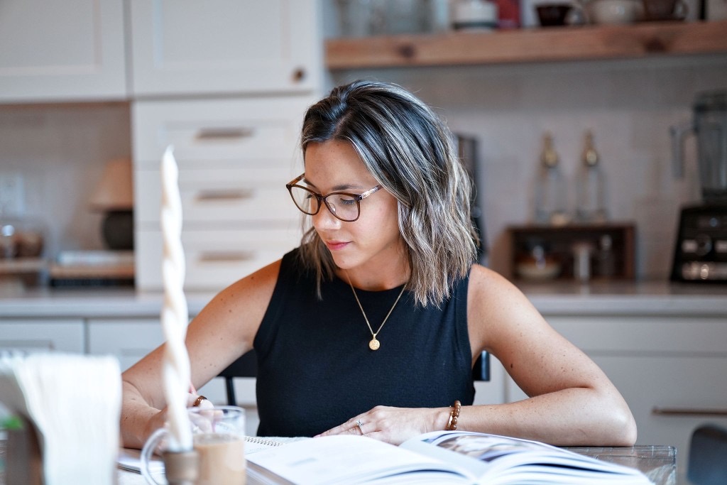 Courtney planning meals at the kitchen table